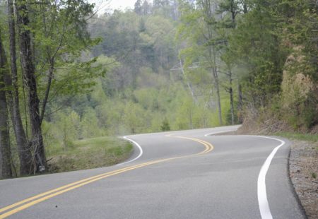 <h2> 5) Deal's Gap in Tennessee </h2>

Imagine riding a motorcycle along a dragon's tail. You're turning left, your turning right, you're leaning left, you're leaning right. That's what Deal's Gap feels like, hence the nickname, Tail of the Dragon. Close to the border of The Great Smoky Mountains National Park, The Dragon is extremely challenging and full of curves. 318 curves along 11 miles to be exact. You're sideways pretty much the whole time! Ride along vibrant forest and green mountains. Challenging for beginners and experts, Deal's Gap will keep you on your toes the whole time.